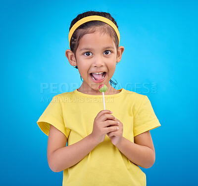 Buy stock photo Young girl, portrait and lollipop with a student feeling happy with a smile and blue background. Isolated, cute and adorable child face with happiness, joy and cheerful from dessert and sweet