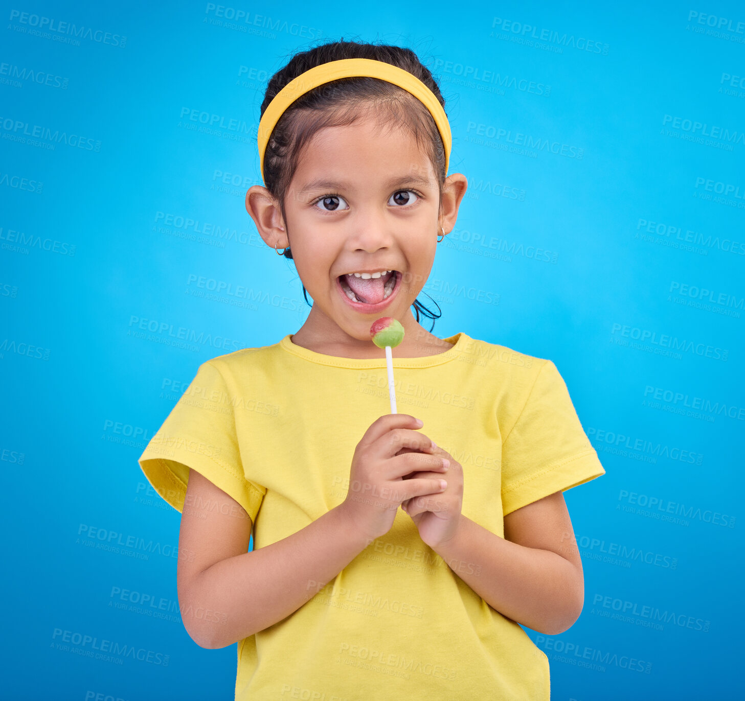 Buy stock photo Young girl, portrait and lollipop with a student feeling happy with a smile and blue background. Isolated, cute and adorable child face with happiness, joy and cheerful from dessert and sweet
