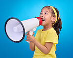 Communication, speech and child with megaphone for news, opinion and announcement on blue background. Talking, speaking mockup and young girl with microphone for voice, scream and attention in studio