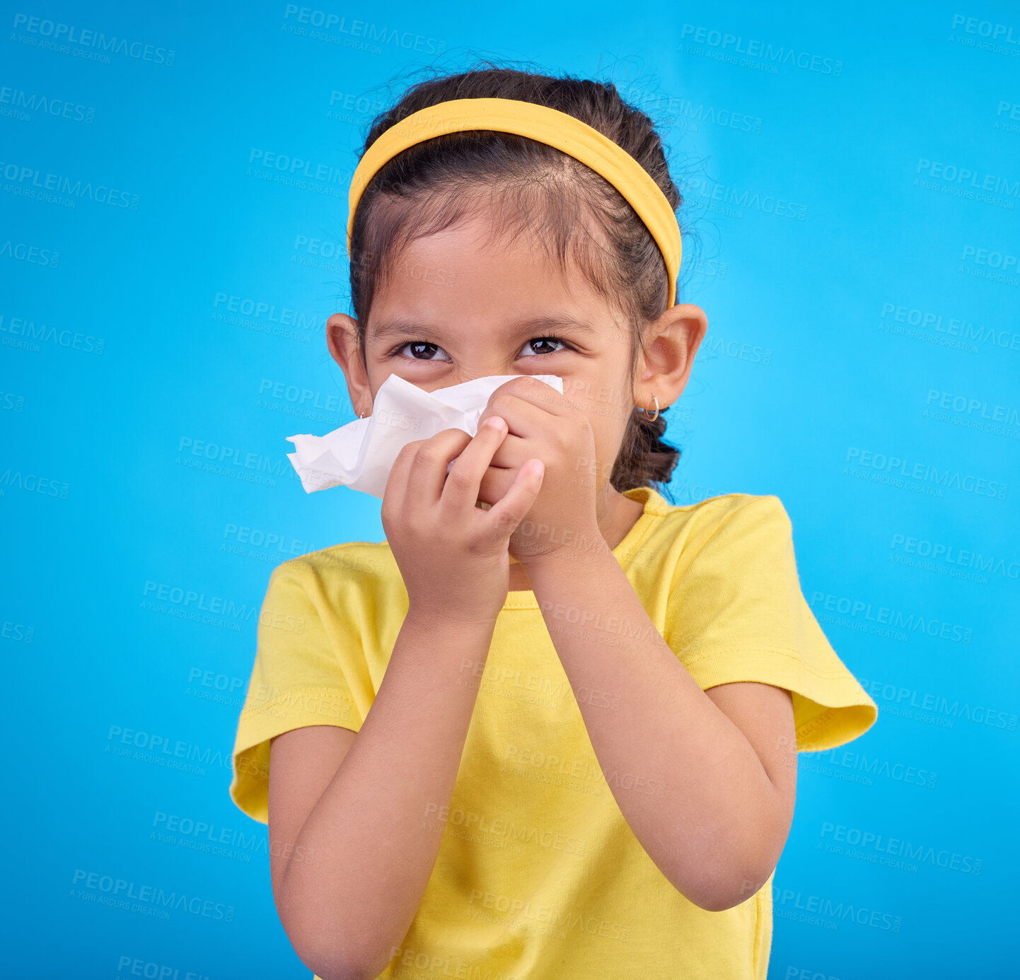 Buy stock photo Sick, blowing nose and napkin with girl in studio for allergies, illness and sneezing. Hay fever, bacteria and sinus issue with child and tissue isolated on blue background for health, medical or flu
