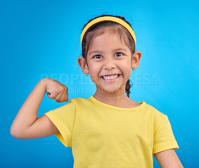 Buy stock photo Strong, happy and portrait of a child with muscle isolated on a blue background in a studio. Excited, smile and girl kid showing biceps, arms and power from exercise with confidence on a backdrop