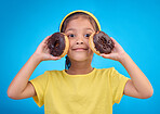 Donut, happy and smile with portrait of girl in studio for junk food, sugar and happiness. Snack, cake and cute with face of child and dessert for cute, positive and chocolate on blue background