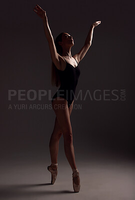 Buy stock photo Ballet, woman and dancer with routine, fitness and training for performance on a dark studio background. Female performer, lady and ballerina with wellness, focus and commitment for art or creativity