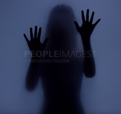 Buy stock photo Shadow, glass and hands with a woman in studio on a blue background for mystery or sensual secrecy. Creative, silhouette and window with a female posing for beauty, art deco or feminine desire