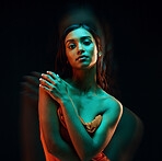 Green light, fashion and Indian woman with beauty, glowing skin and luxury brand aesthetic. Creative lighting, young female and model with a dark background in a studio with modern style and makeup