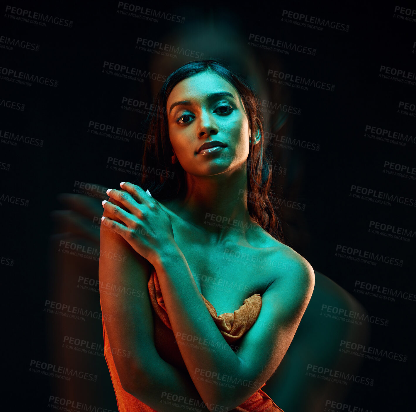 Buy stock photo Green light, fashion and Indian woman with beauty, glowing skin and luxury brand aesthetic. Creative lighting, young female and model with a dark background in a studio with modern style and makeup