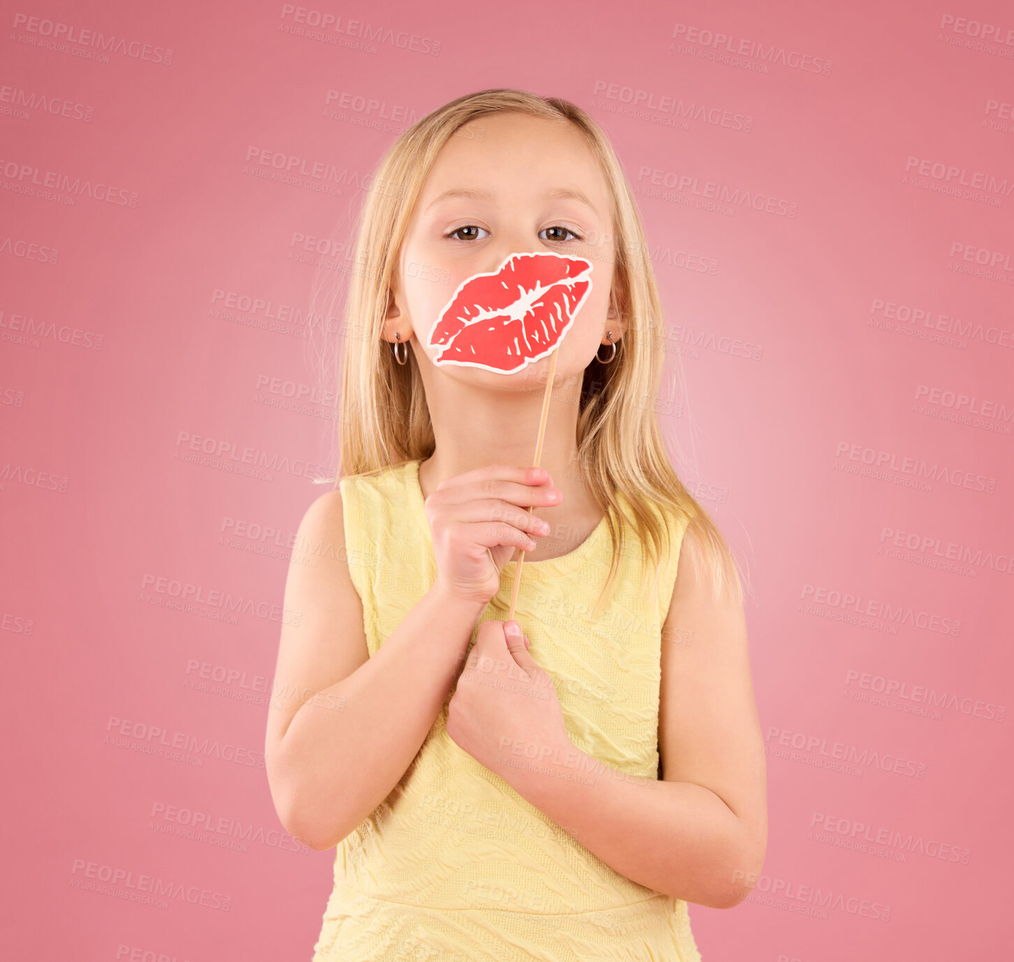 Buy stock photo Portrait, children and lips with a girl on a pink background in studio holding a mouth prop. Kids, emoji and kiss with an adorable little female child holding a cardboard shape for valentines day