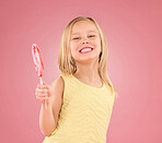 Candy, smile and lollipop with portrait of girl in studio for sugar, party and carnival food isolated on pink background. Cute, positive and youth with child and eating snack for playful and treats  