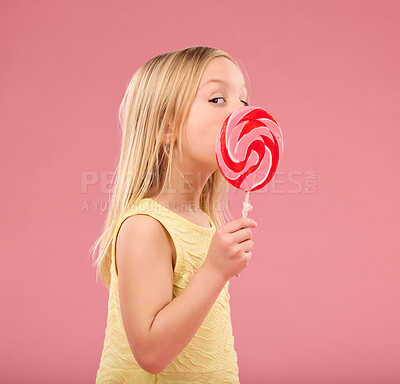 Buy stock photo Candy, sweets and lollipop with girl in studio for sugar, party and carnival food isolated on pink background. Cute, positive and youth with child and eating colorful snack for playful and treats  