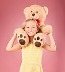 Teddy bear, girl smile and portrait with a soft toy with happiness and love for toys in a studio. Isolated, pink background and a young female child feeling happy, joy and cheerful with friend