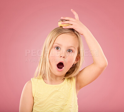 Buy stock photo Child, donut and wow face portrait in studio with hand on head on a pink background. Girl kid model with sweet snack, surprise and shocked or comic expression isolated on creative color and space