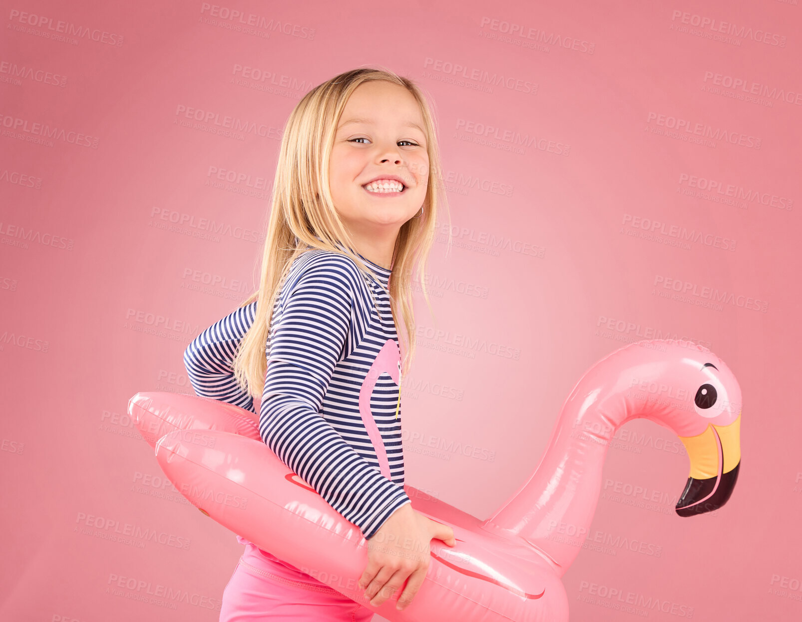 Buy stock photo Happy, portrait and pool float with girl in studio for swimming, summer break or cute. Youth, funny and inflatable with child and flamingo ring for relax, smile or beach holiday on pink background
