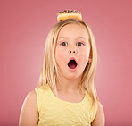 Child, wow and donut portrait in studio with surprise on head on a pink background. Face of a girl kid model with mouth open, shocked and comic chocolate snack isolated on creative color and space