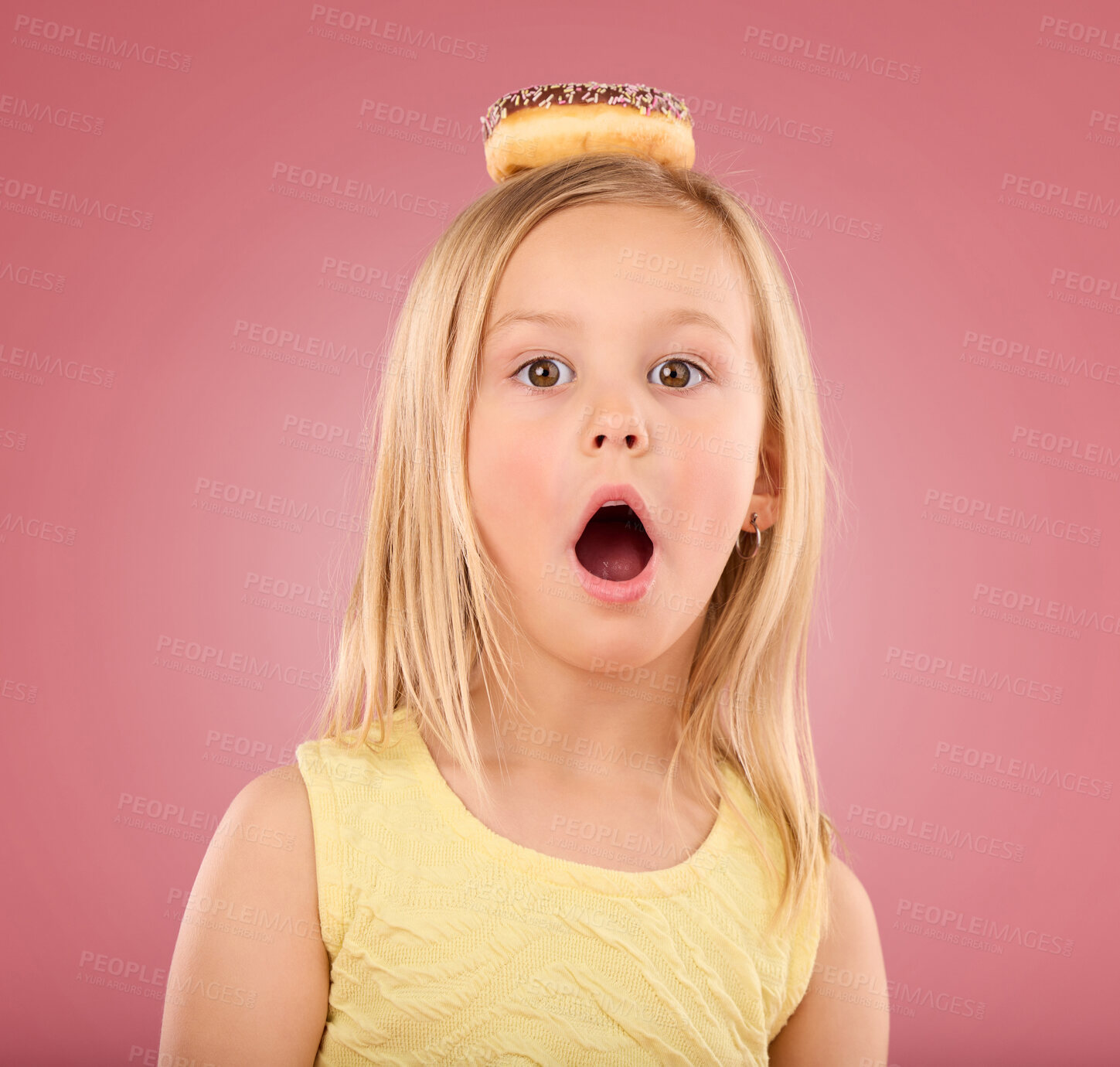 Buy stock photo Child, wow and donut portrait in studio with surprise on head on a pink background. Face of a girl kid model with mouth open, shocked and comic chocolate snack isolated on creative color and space