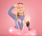 Safety, smile and portrait of girl and pool float for swimming, summer break or happiness. Youth, funny and inflatable with child and flamingo ring for pool, smile or beach holiday on pink background
