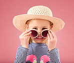 Vacation, portrait of child in studio with sunglasses and fun clothes and hat isolated on pink background. Summer, holiday and fashion, happy girl in Australia excited for travel with smile on face.