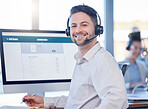 Man at call center, contact us with customer service employee, smile and CRM with consultant at desk. Professional, portrait and communication, male with headset with help desk and telemarketing