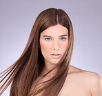 Portrait, hair and breeze with a model woman in studio on a gray background for haircare or keratin treatment. Shampoo, salon and beauty with an attractive young female posing in a wind on a wall