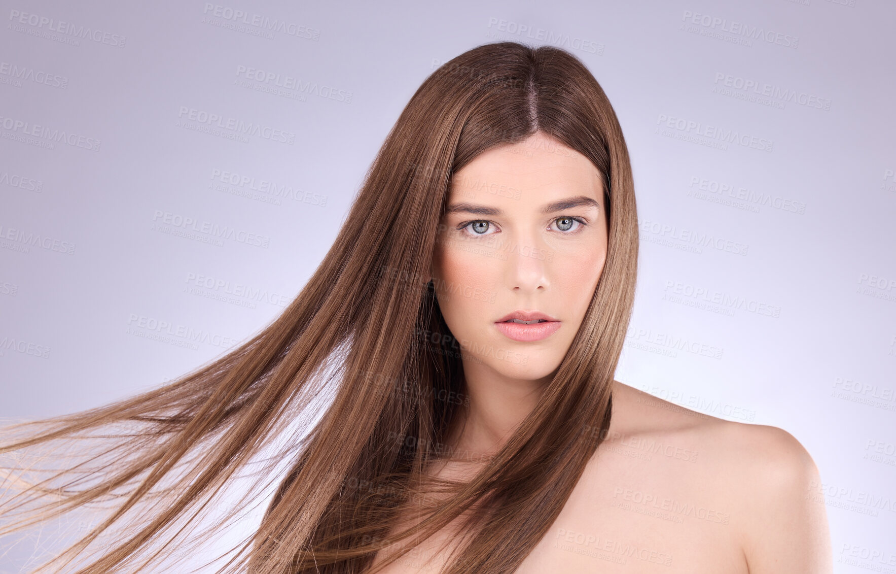 Buy stock photo Portrait, hair and windy with a model woman in studio on a gray background for haircare or keratin treatment. Shampoo, salon and beauty with an attractive young female posing in a breeze on a wall