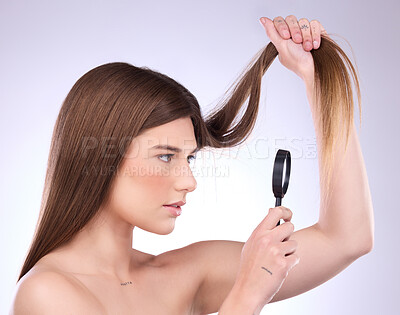 Buy stock photo Magnifier, haircare and woman with magnifying glass checking hair damage isolated in a studio white background. Beauty, treatment and sad female model doing hairstyle health inspection of growth