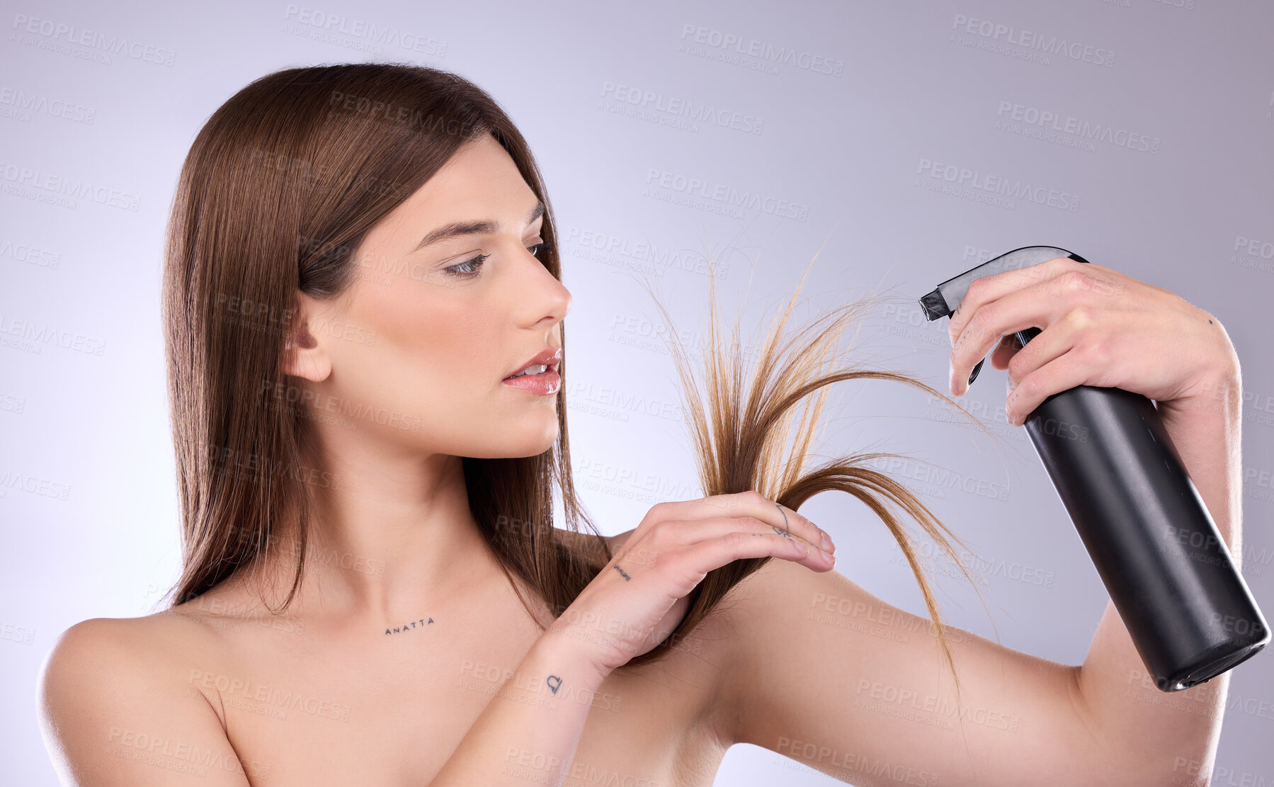 Buy stock photo Hair care, split ends and woman with spray in studio isolated on a gray background. Cosmetics product, damage and female model with hairspray bottle for salon treatment and hairstyle moisturizer.