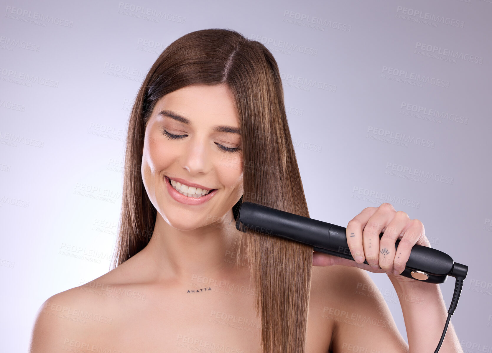 Buy stock photo Hair straightener, face and beauty smile of woman in studio isolated on a gray background. Haircare, happy and young female model with flat iron product for salon treatment, balayage or hairstyle.