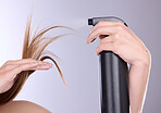 Hair care, beauty and hands with spray in studio isolated on a gray background. Cosmetics product, keratin and model woman with hairspray bottle for salon treatment, growth and hairstyle moisturizer.