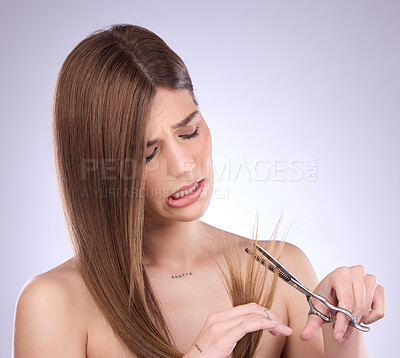 Buy stock photo Scissors, beauty and woman cutting hair in studio, trim and split ends removal against a grey background. Haircare, model and girl with tool for tips, styling and hairstyle while posing isolated