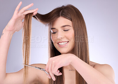 Buy stock photo Beauty, style and woman cutting her hair in studio on a gray background for grooming or care. Salon, shampoo and haircut with an attractive young female trimming her hairstyle for haircare