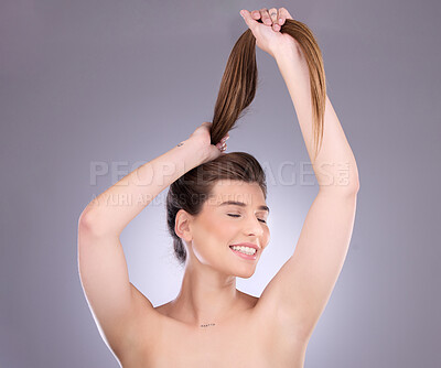 Buy stock photo Eyes closed, beauty and hair care of a woman in studio isolated on a gray background. Cosmetics, growth or happy female model with salon treatment for healthy keratin, balayage or long hairstyle pull