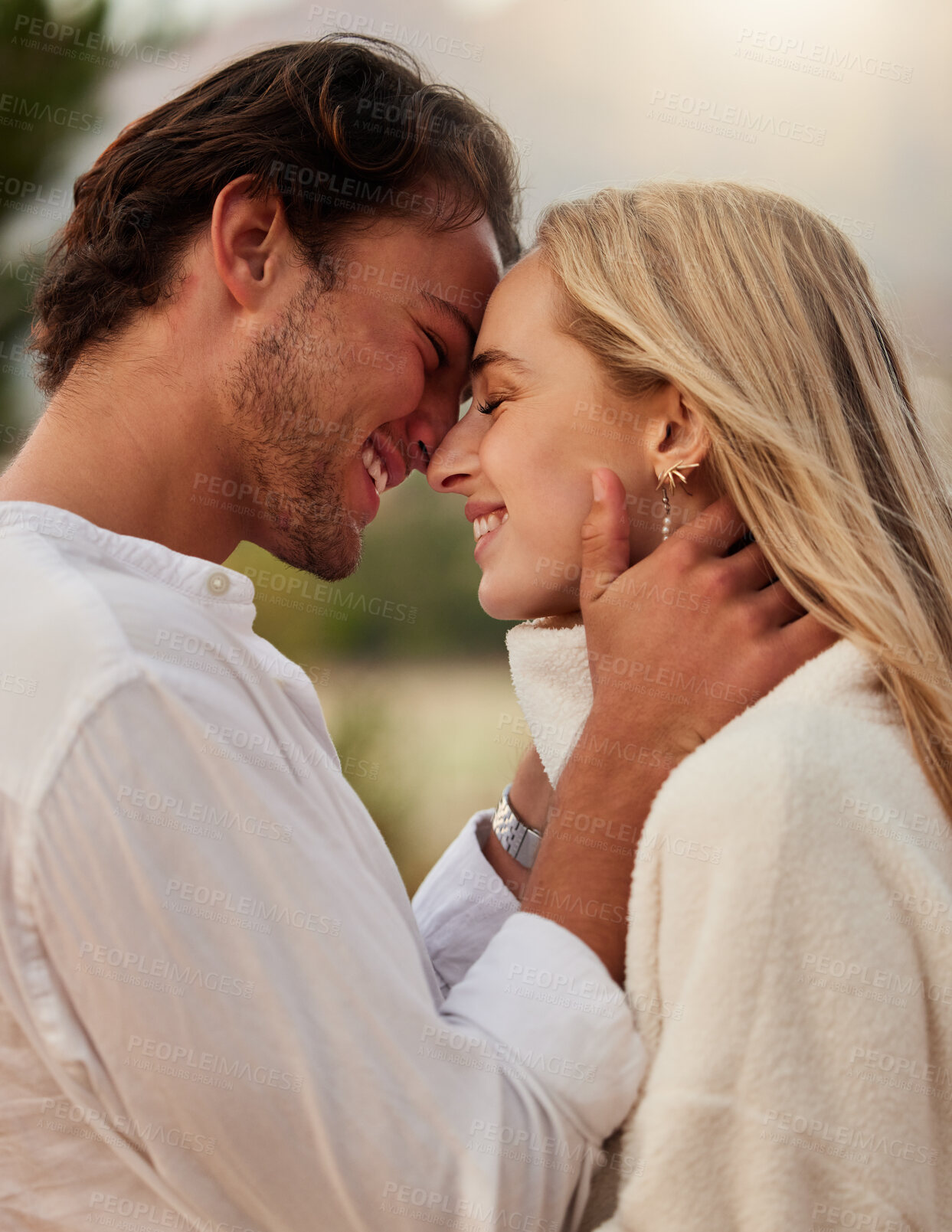 Buy stock photo Love, care and kiss with couple in nature for romance, bonding and affectionate together. Close, happiness and embrace with man and woman hugging on date for sunset, anniversary and summer break