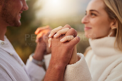 Buy stock photo Love, smile and couple holding hands at sunset for bonding, quality time and romantic weekend. Dating, honeymoon and man and woman with palms together for trust, support and loving for valentines day