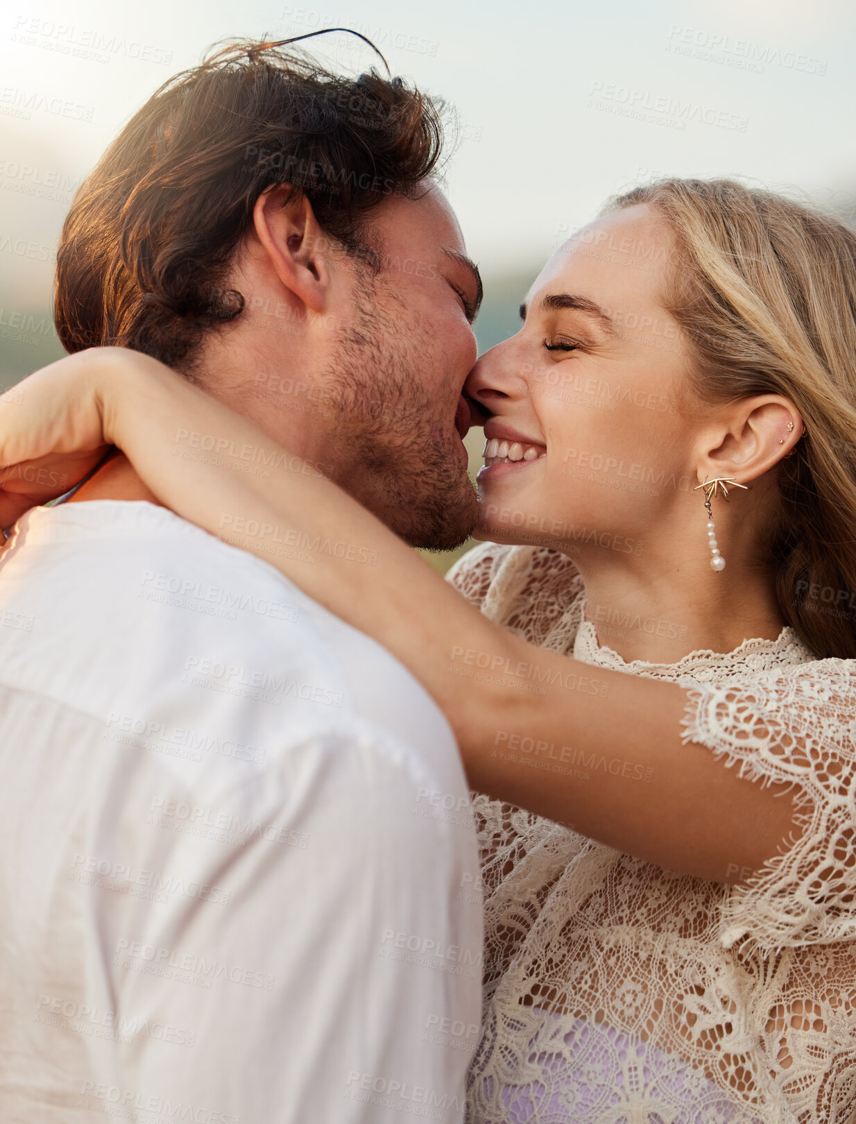 Buy stock photo Couple, kiss and hug outdoor with a smile, love and romance on date in nature. Young man and woman happy together on valentines day with trust, peace and freedom or support in forest for anniversary