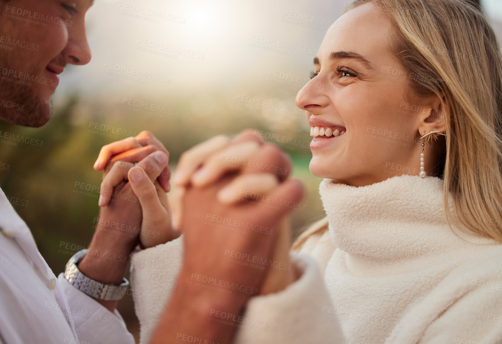 Buy stock photo Holding hands, couple and love outdoor with a smile, care and romance on date in nature. Young man and woman happy together on valentines day with trust, peace and support in forest for anniversary