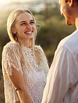 Happy, smile and couple in nature at sunset for romance, bonding and quality time together outdoors. Love, dating and man and woman holding hands on holiday, honeymoon vacation and relax on weekend