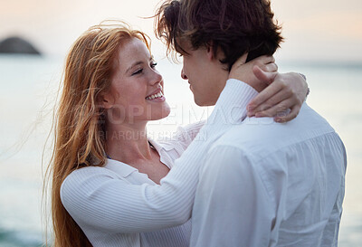 Buy stock photo Love, hug and smile with couple at beach for romance, relax and vacation trip. Travel, sweet and cute relationship with man and woman embracing on date for summer break, affectionate and bonding