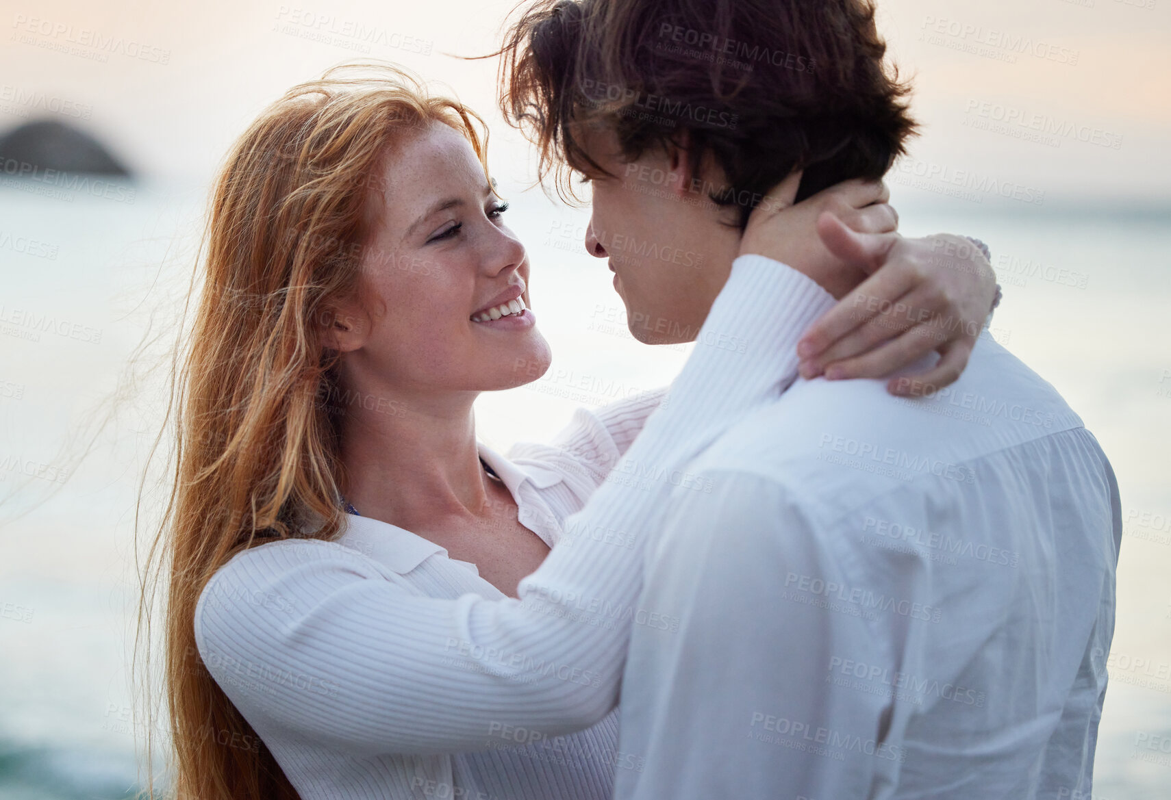 Buy stock photo Love, hug and smile with couple at beach for romance, relax and vacation trip. Travel, sweet and cute relationship with man and woman embracing on date for summer break, affectionate and bonding