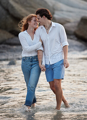Buy stock photo Love, romance and couple in the water at the beach holding hands while on a vacation together. Happy, smile and young man and woman walking in ocean or sea while on romantic weekend trip in Australia