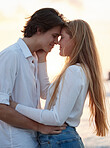 Love, kiss and sunset with couple at beach for romance, relax and vacation trip. Travel, sweet and cute relationship with man and woman hugging on date for summer break, affectionate and bonding