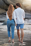 Couple walking on beach, holding hands and travel with love and commitment in relationship, adventure and romance. Trust, partnership and care with people outdoor, tropical holiday and back view