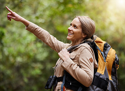 Buy stock photo Hiking, pointing or happy woman in nature, forest or wilderness for a trekking adventure. Freedom, backpack excited female hiker walking in a natural park or woods for exercise or wellness on holiday