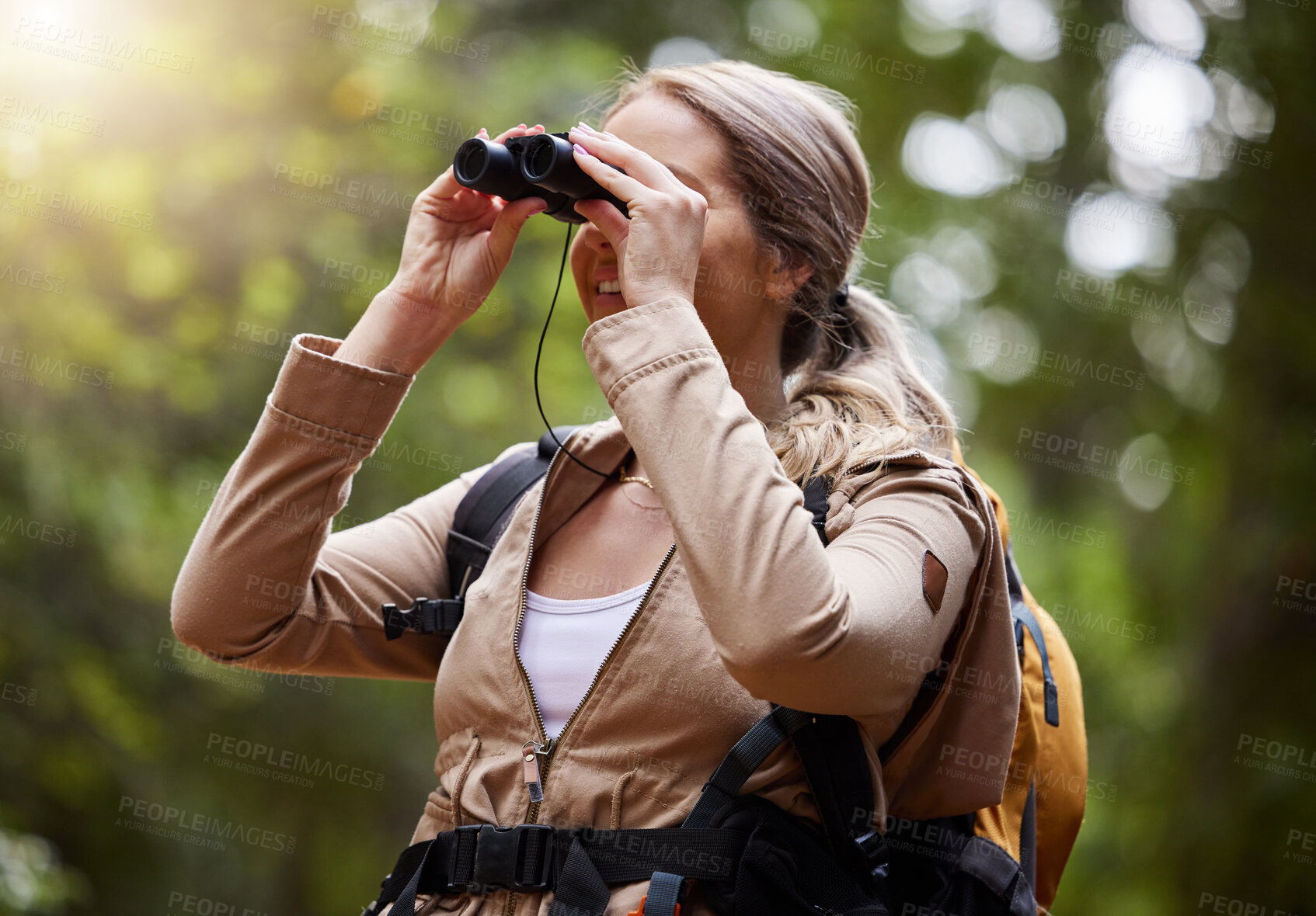 Buy stock photo Binoculars, forest explore and woman on travel journey, jungle adventure or hiking for carbon footprint holiday. Happy hiker person trekking in tropical woods or eco green environment search or watch