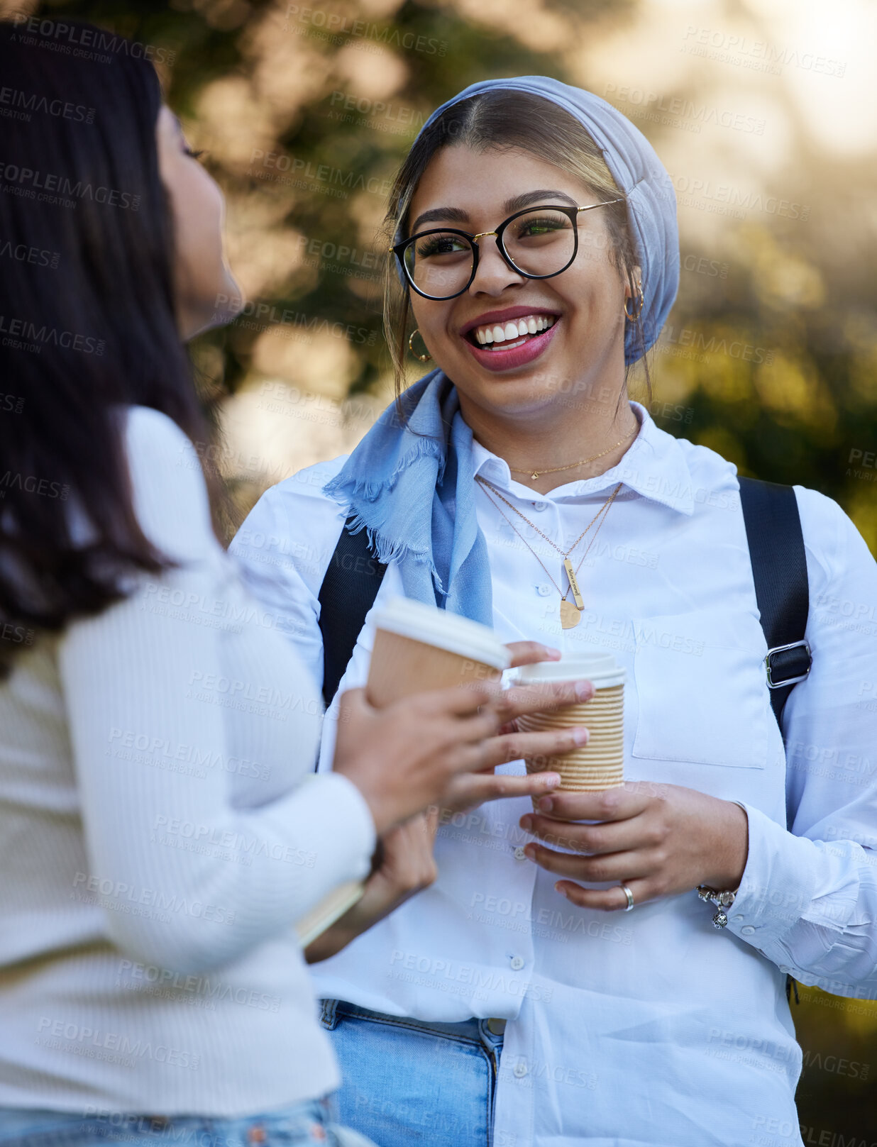 Buy stock photo Happy, break or students talking at park on university campus for learning, education or goals together. Girls talk, Islamic or students relaxing with coffee meeting for research or college knowledge