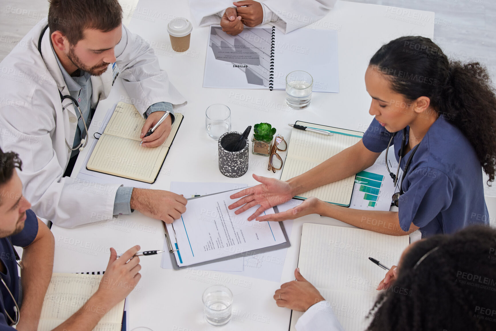 Buy stock photo Above discussion of medical teamwork, meeting or paperwork report of test results at table. Diversity, hospital doctors and healthcare documents of research, surgery analysis or planning clinic notes