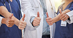 Thumbs up, group hands and teamwork of doctors celebrate success, support and trust in medical clinic. Closeup, healthcare staff and thumb sign in collaboration, agreement and yes emoji of motivation