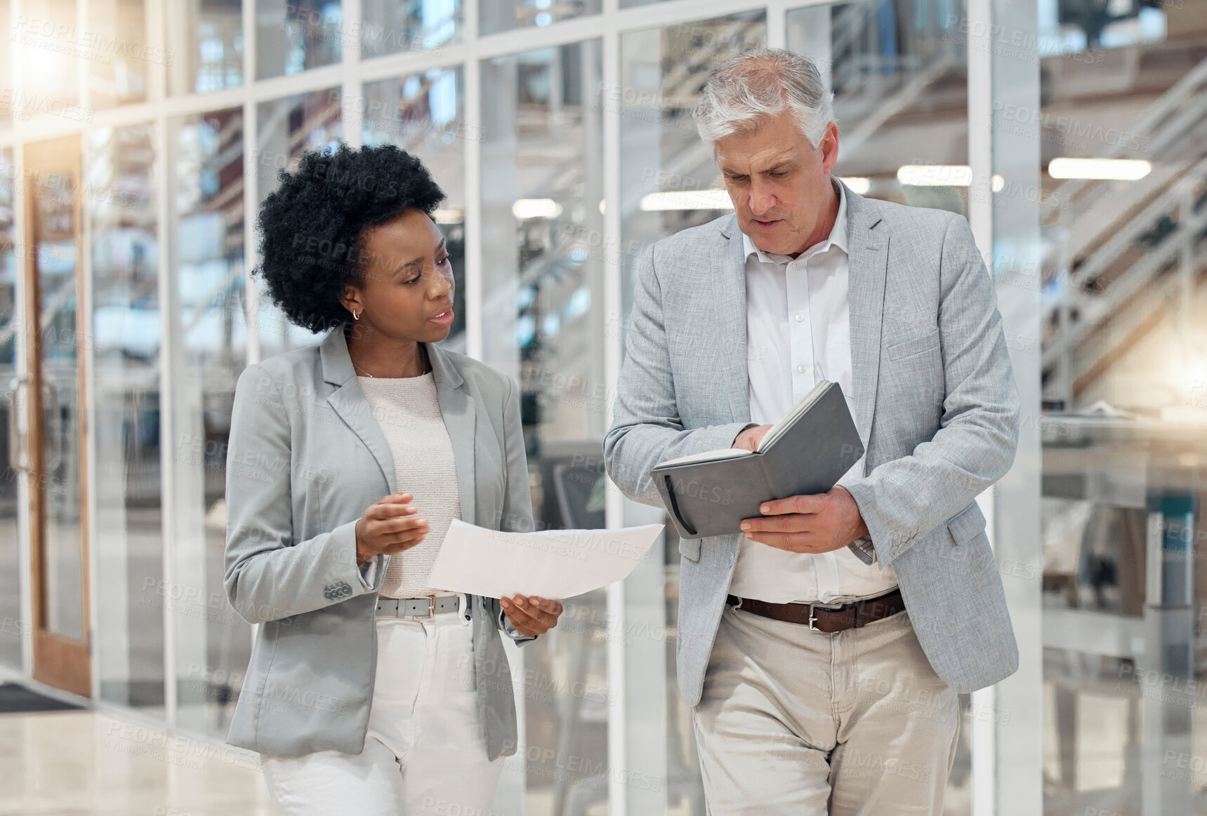 Buy stock photo Business, office and employees walking, planning and discussion for new project, report and feedback. Coworkers, male manager and female leader with notebook, documents and conversation in workplace