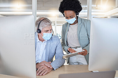 Buy stock photo Covid, crm and black woman coaching man with tablet and mask at help desk or call center. Compliance, consulting and opinion, data or statistics for medical advisory agency with diversity and trust.