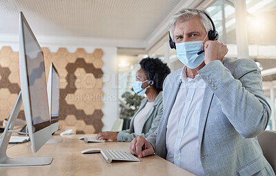 Buy stock photo Covid, portrait and man in a call center for service, online help and advice on a computer. Talking, telemarketing and mature customer support employee wearing a face mask while consulting on a pc