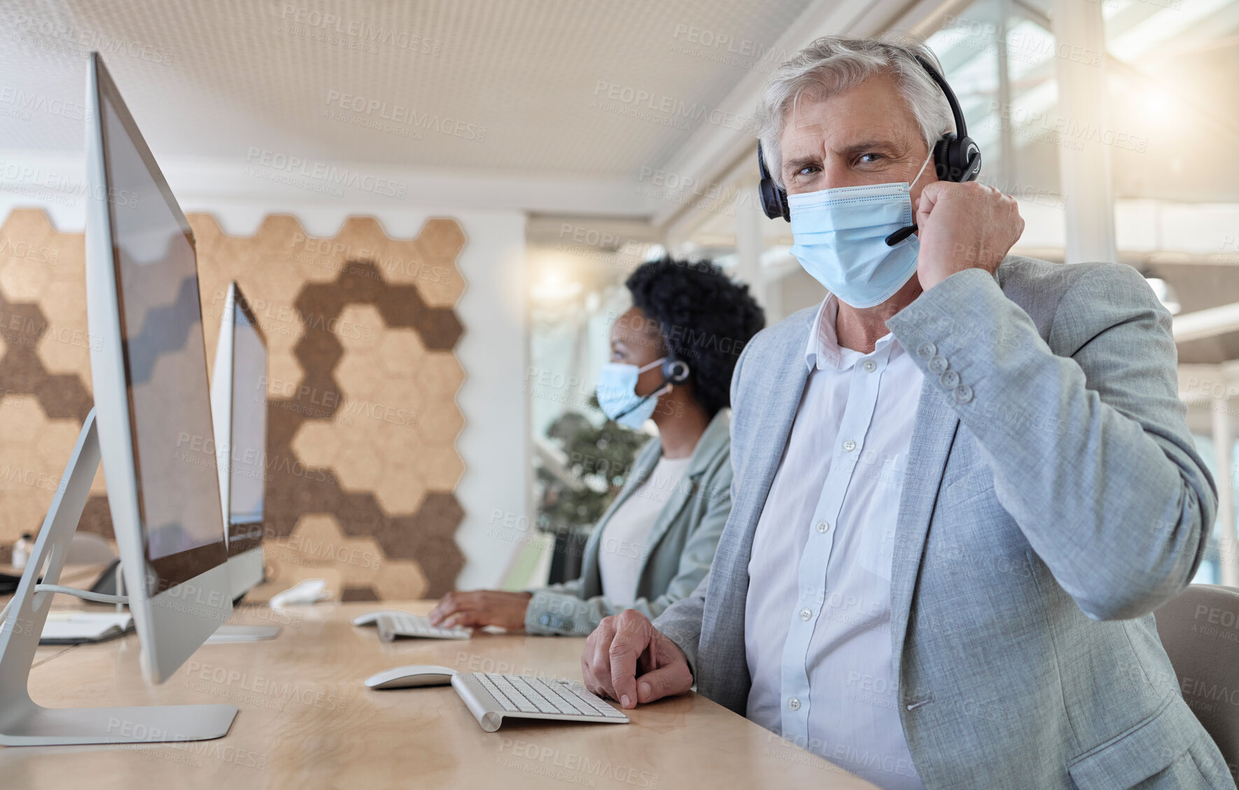 Buy stock photo Covid, portrait and man in a call center for service, online help and advice on a computer. Talking, telemarketing and mature customer support employee wearing a face mask while consulting on a pc