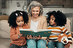 Family kids, book and grandma reading fantasy storybook, story or bond on home living room sofa. Love, grandma babysitting and elderly woman with child development for biracial kindergarten children